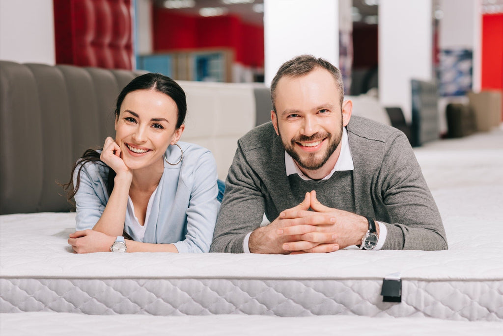 man and wife testing a mattress