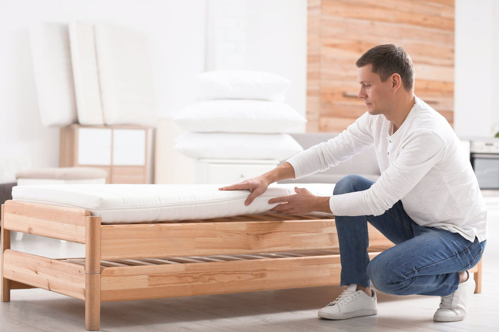man setting up a latex mattress